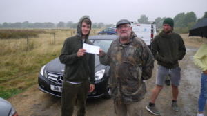 Clive Archer presenting  Jake Banks with £250