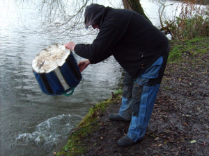 Mickey Emm, returns his catch to the lake, alive & well.